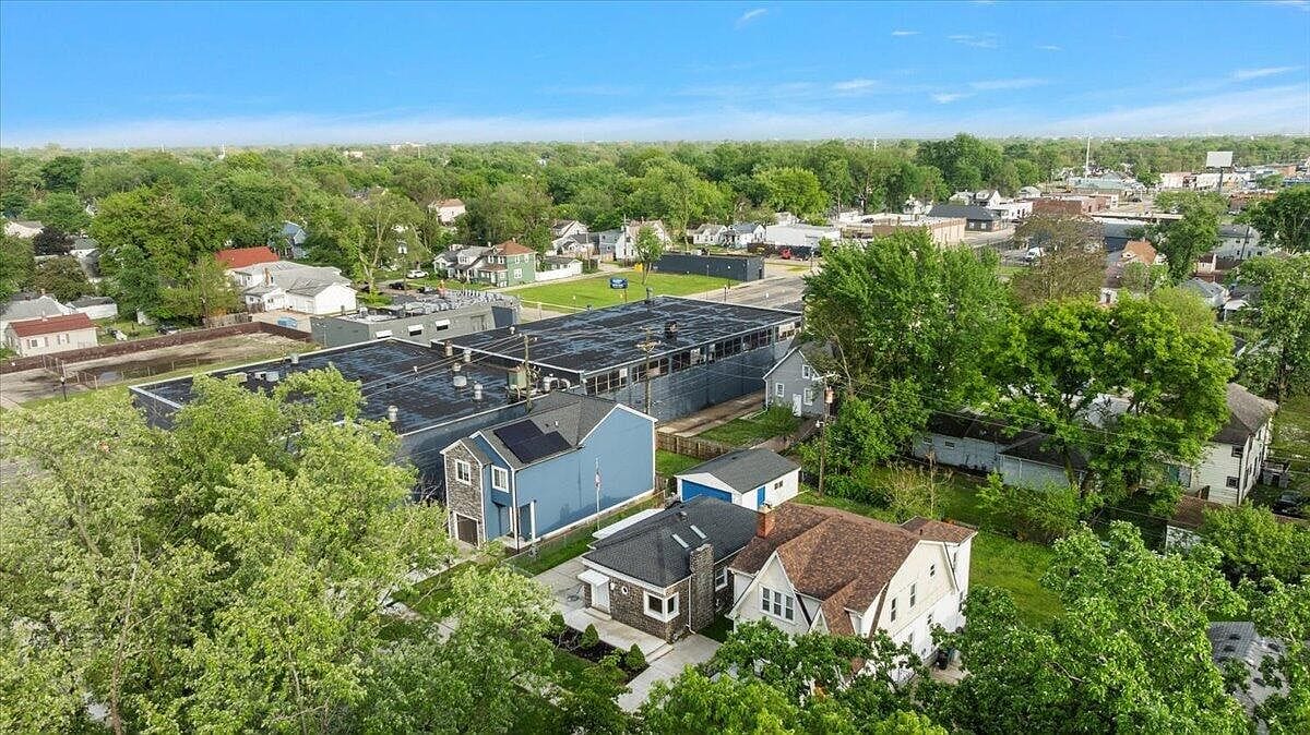 Wider aerial shot showing the commercial properties nearby
