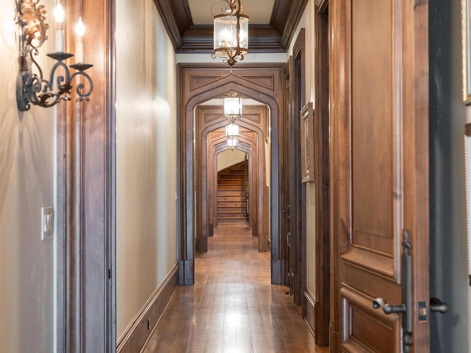 A long hallway with multiple wooden gothic arches