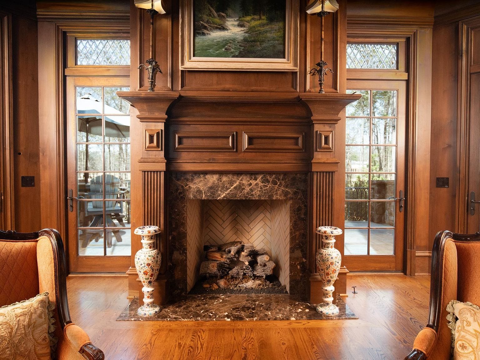 A close-up of the wooden fireplace mantle in the library