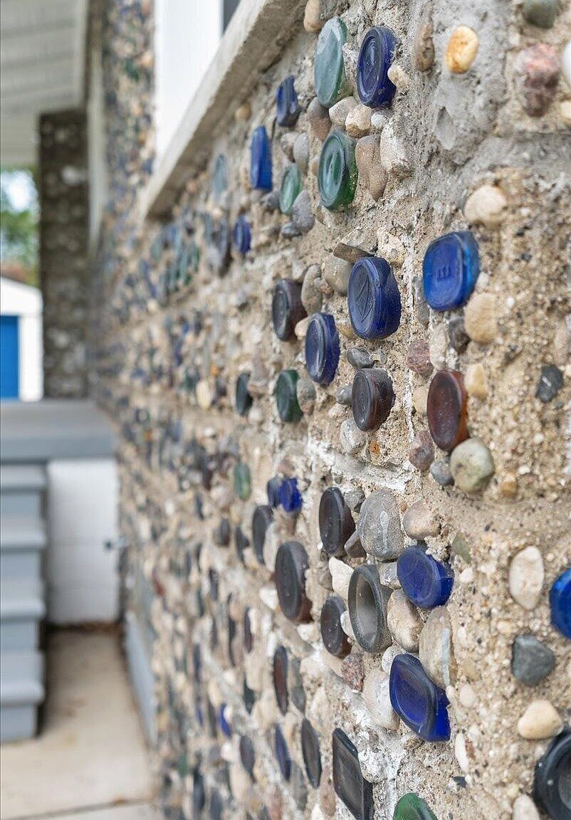 Extreme close up of the colorful bottles embedded in concrete