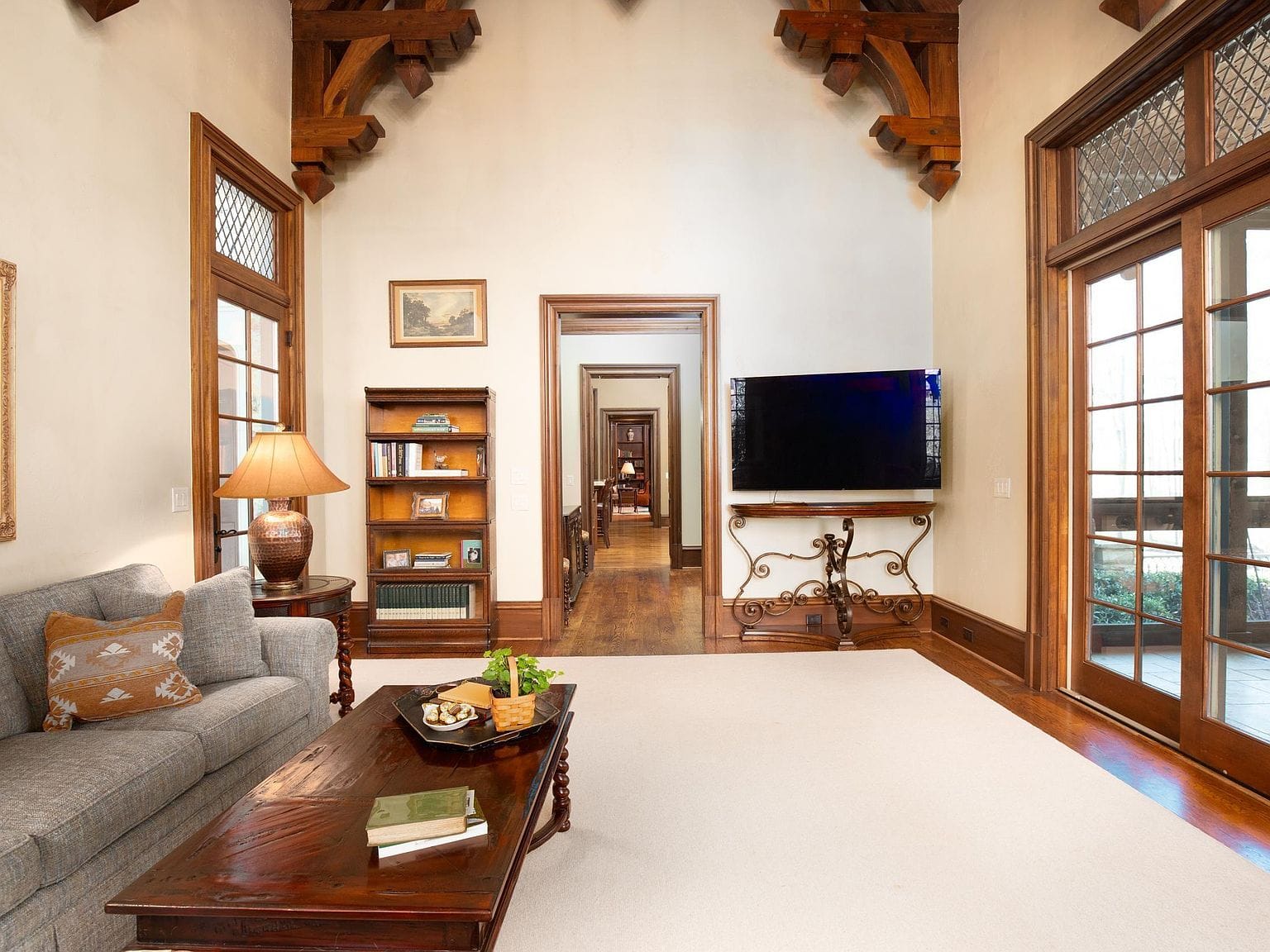 A casual living room with high ceilings and heavy wooden trusses