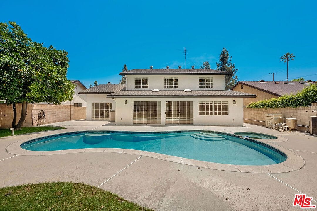 Rear view of the house showing the sliding glass doors and pool