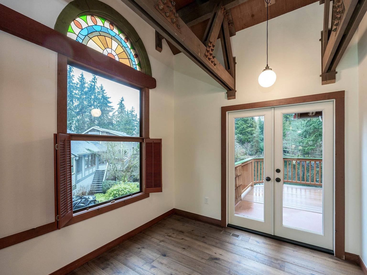 Kitchen doors to deck, stained glass window above