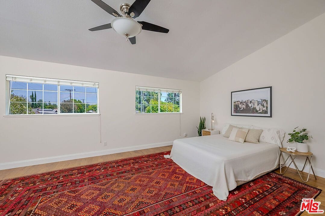 Wide shot of the primary bedroom showing window placements