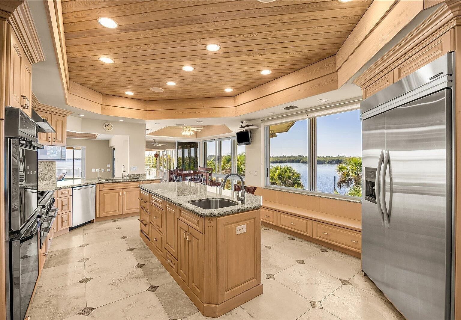 Kitchen island looking out the large windows to the river