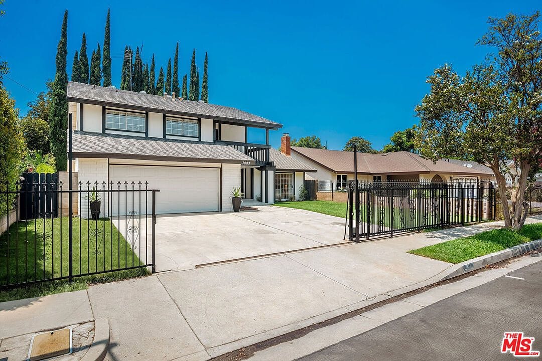 Daytime view of the gated front driveway