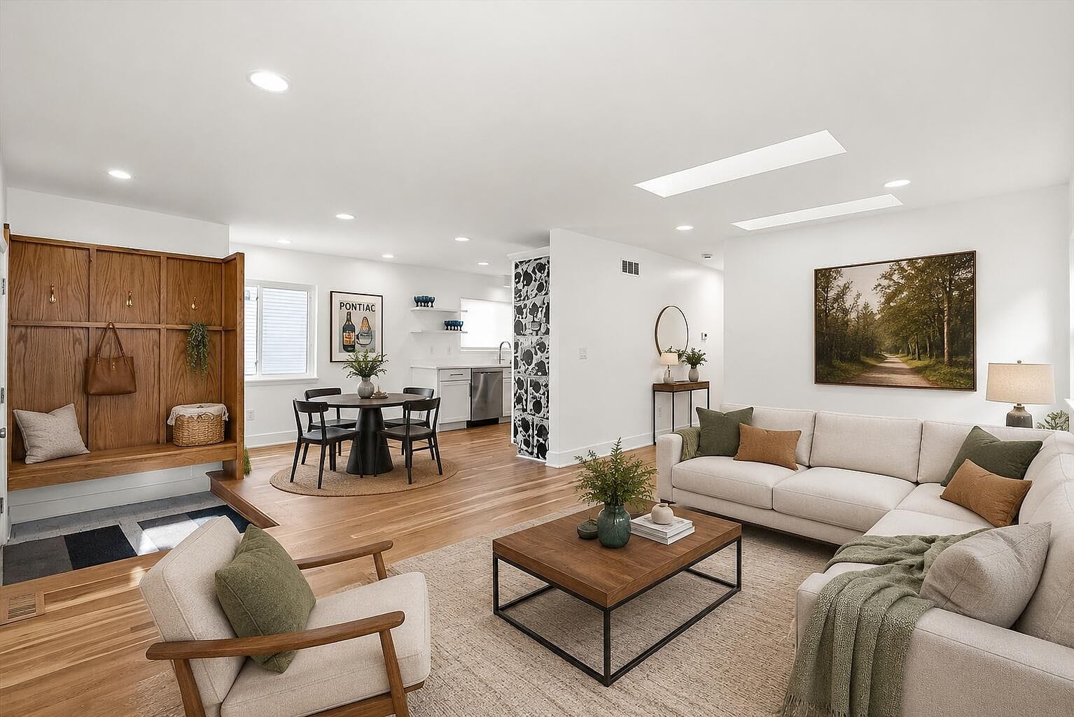 Staged living room with wood floors and recessed lighting