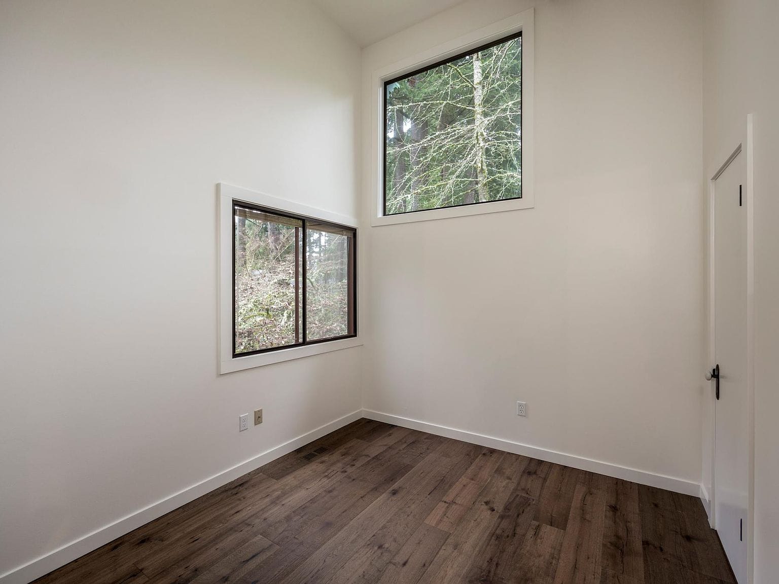 Plain white bedroom with high window