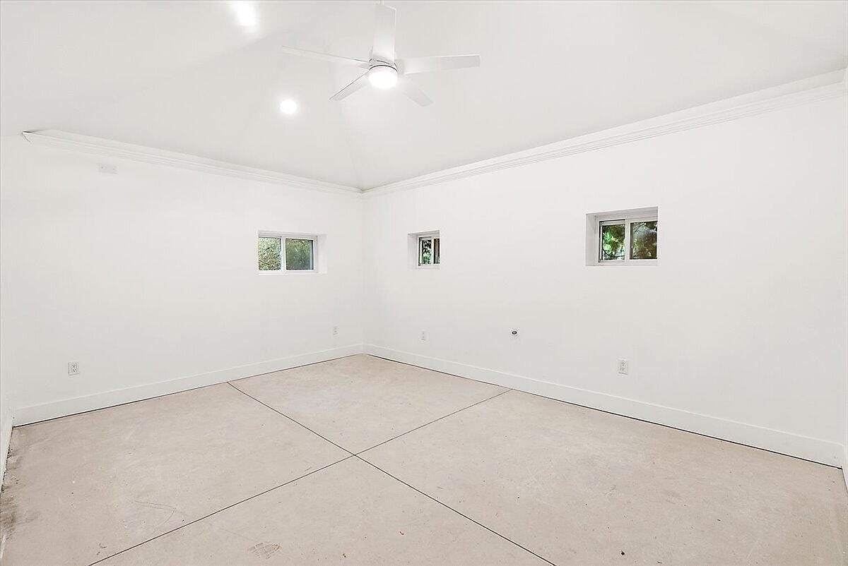 Empty finished flex room with concrete floor