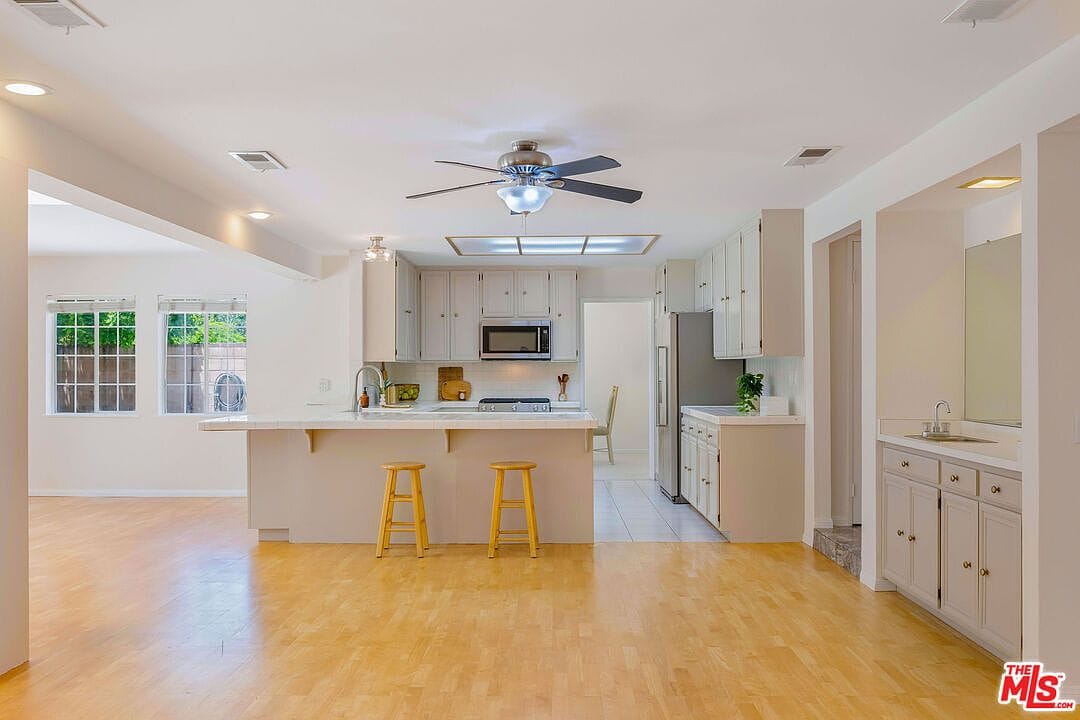 Wide view of the kitchen opening up to the family room