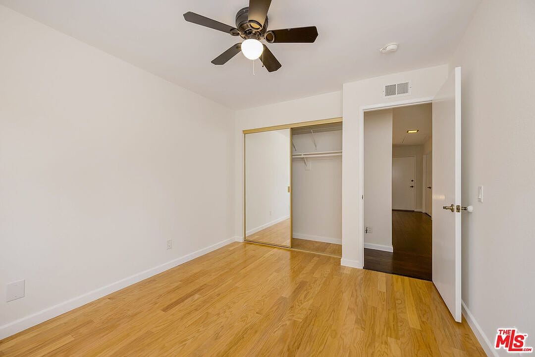 Upstairs bedroom showing mirrored closet and doorway