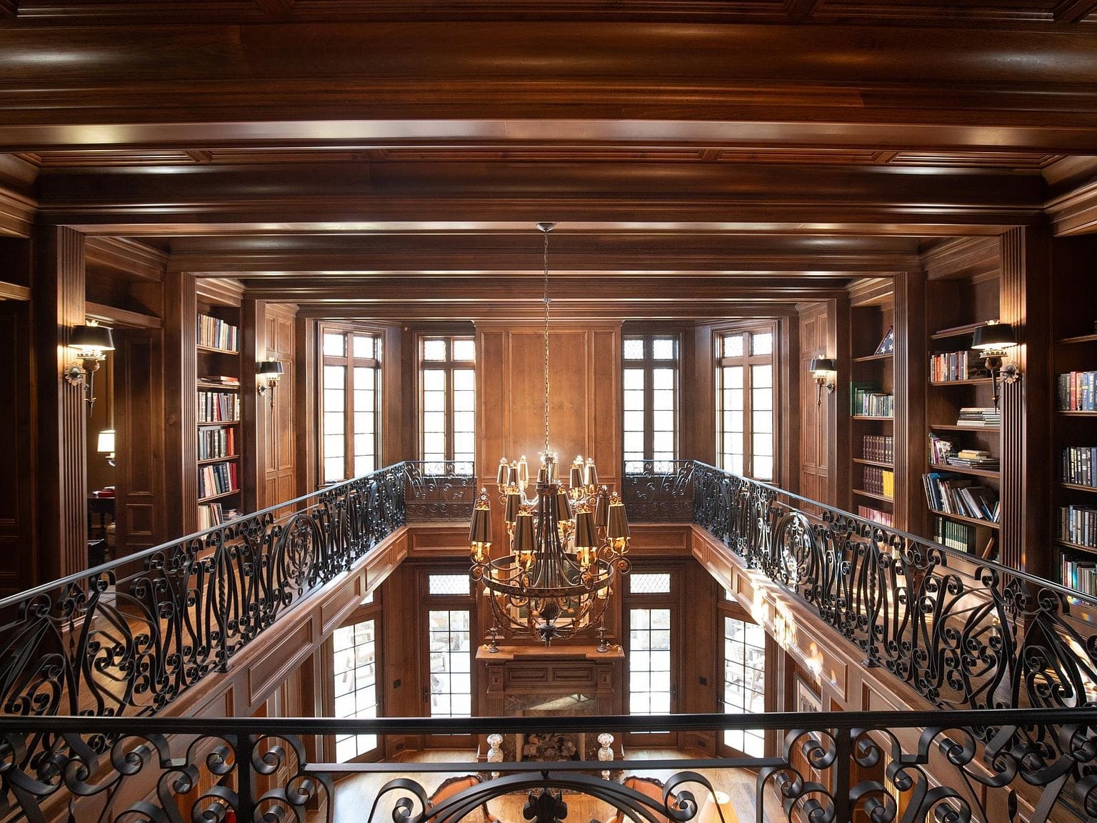 Looking down from the second-floor balcony of the wood-paneled library