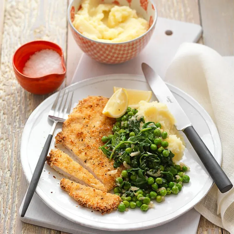 Chicken schnitzel with creamed spinach and peas