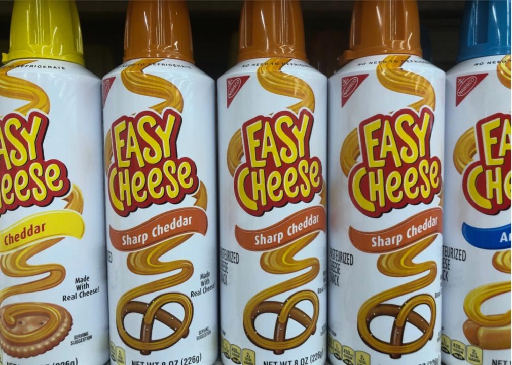 Cheese in a can Close up of cans of "easy cheese" in various flavors.