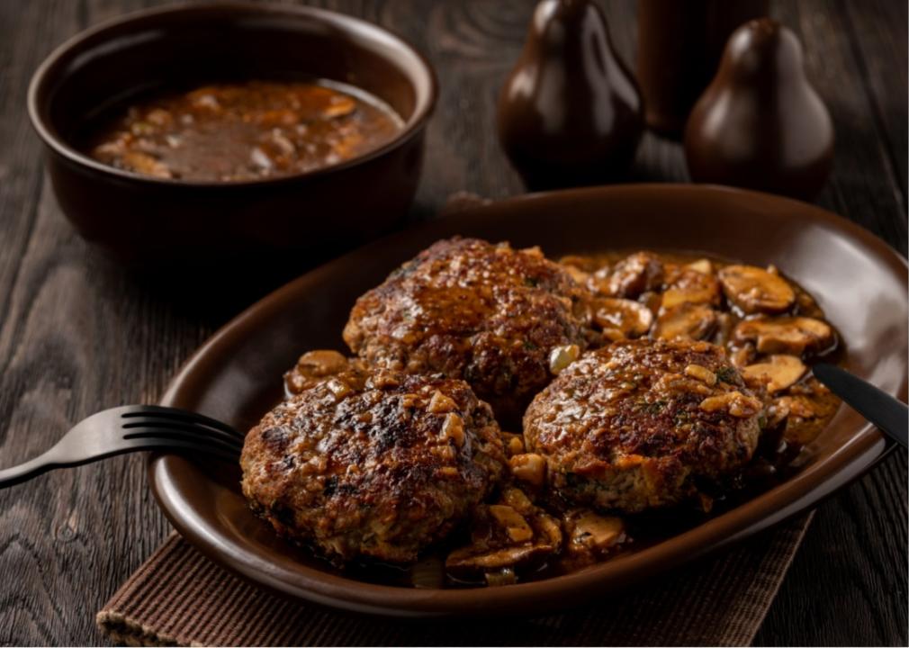 Salisbury steak An oval brown plate with flattened patties of brown meat and mushroom sauce.