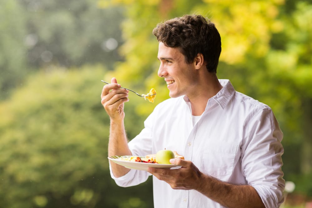 person eating a healthy breakfast with eggs