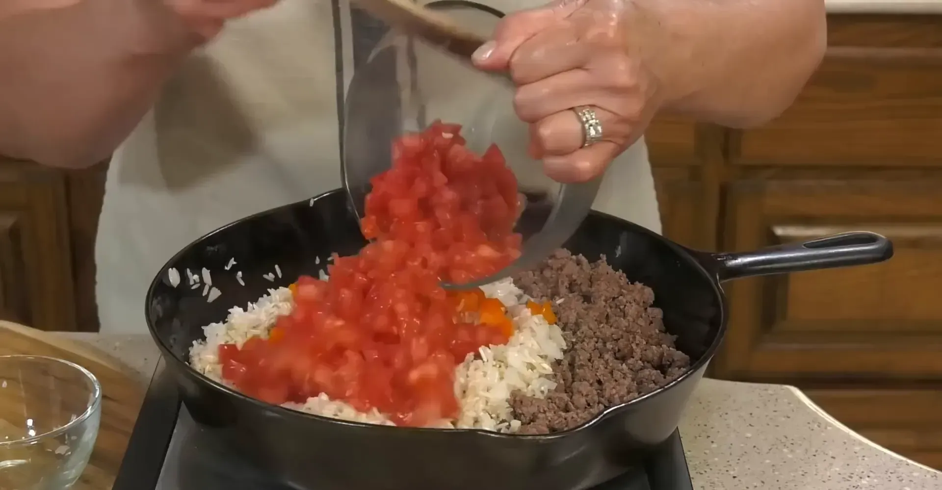 Adding garlic and vegetables to the skillet