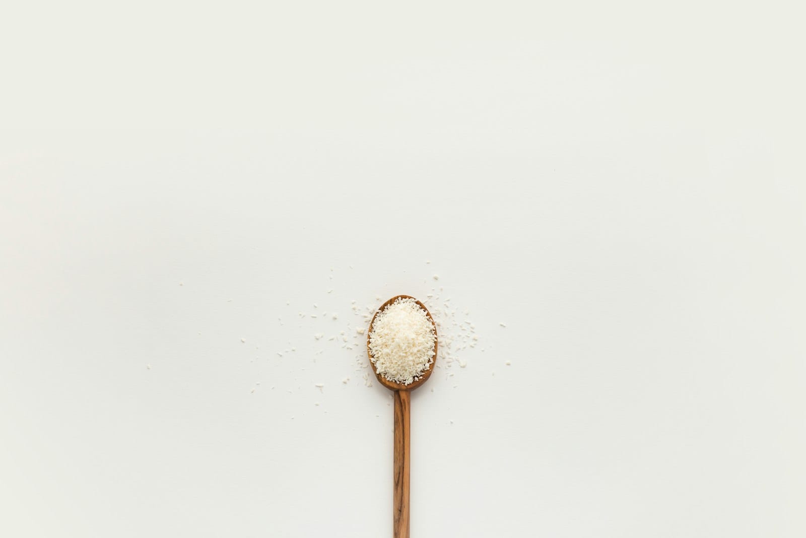 white powder on brown wooden spoon