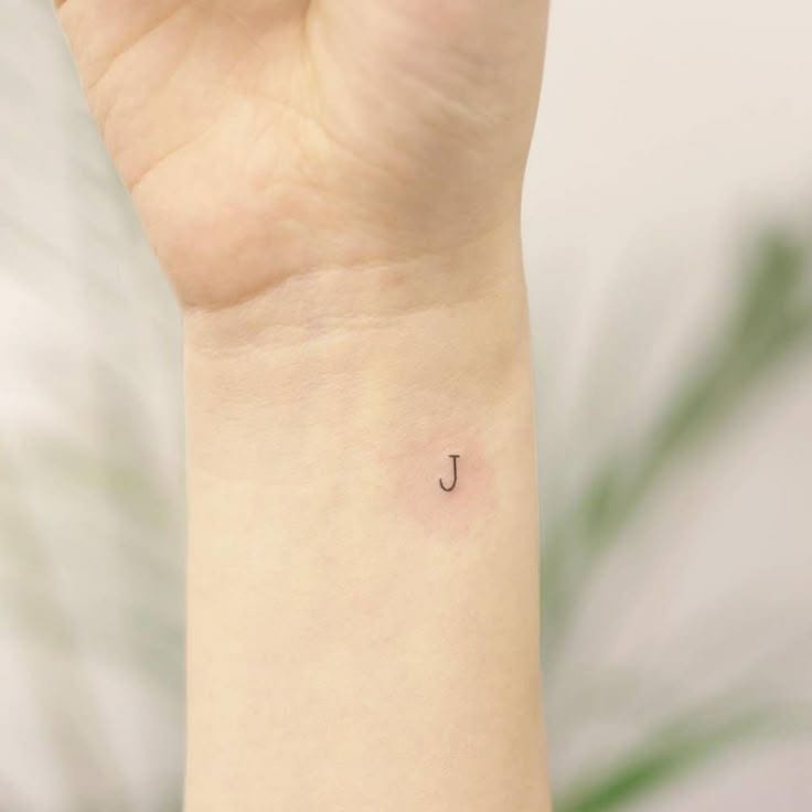minimalist line j tattoo