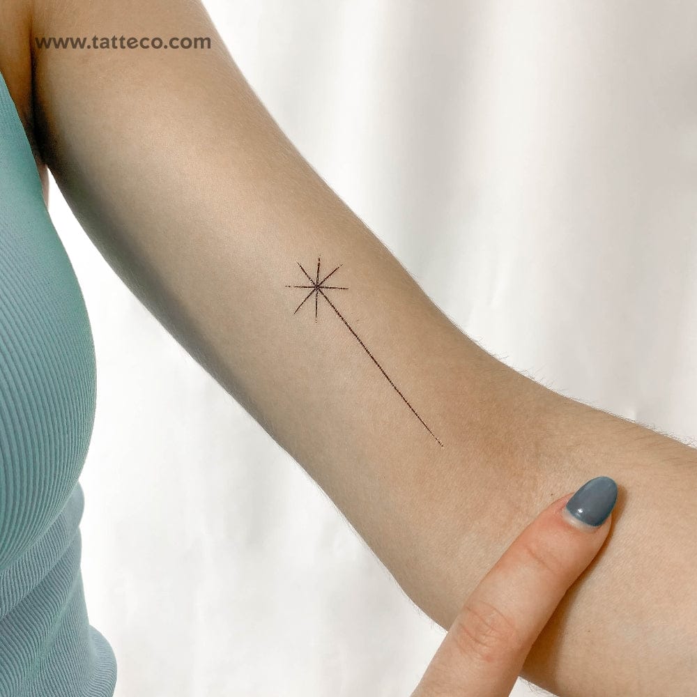 a minimalist shooting star tattoo single star