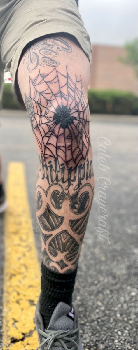 leg spider web tattoo