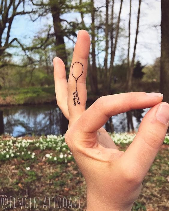 hand pooh tattoo