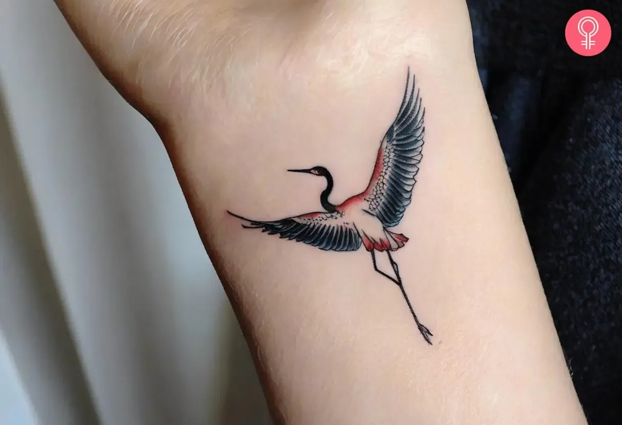 a small Japanese tattoo with a crane
