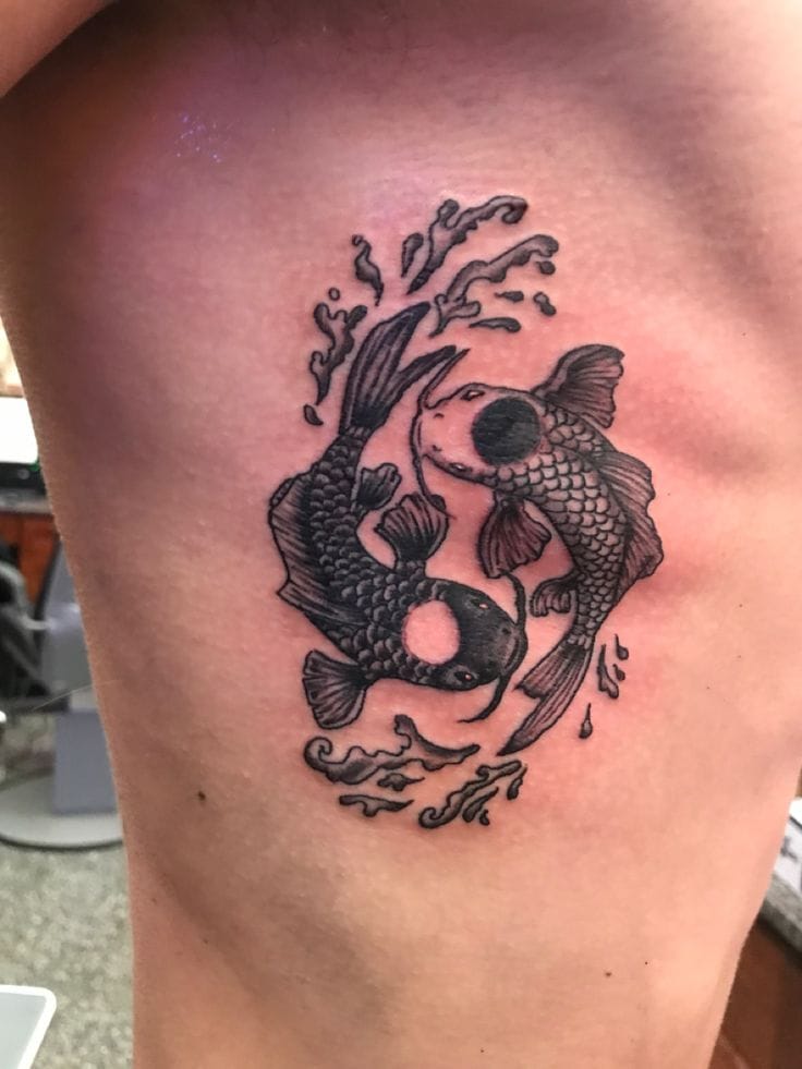 a ribs tattoo with a yin and yang