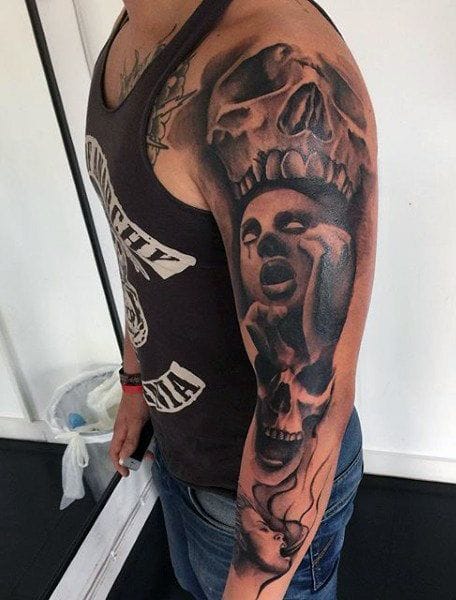 an upper arm tattoo with demon design