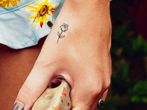 small hand rose tattoo
