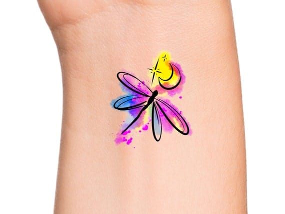 a beautiful firefly tattoo with crescent moon