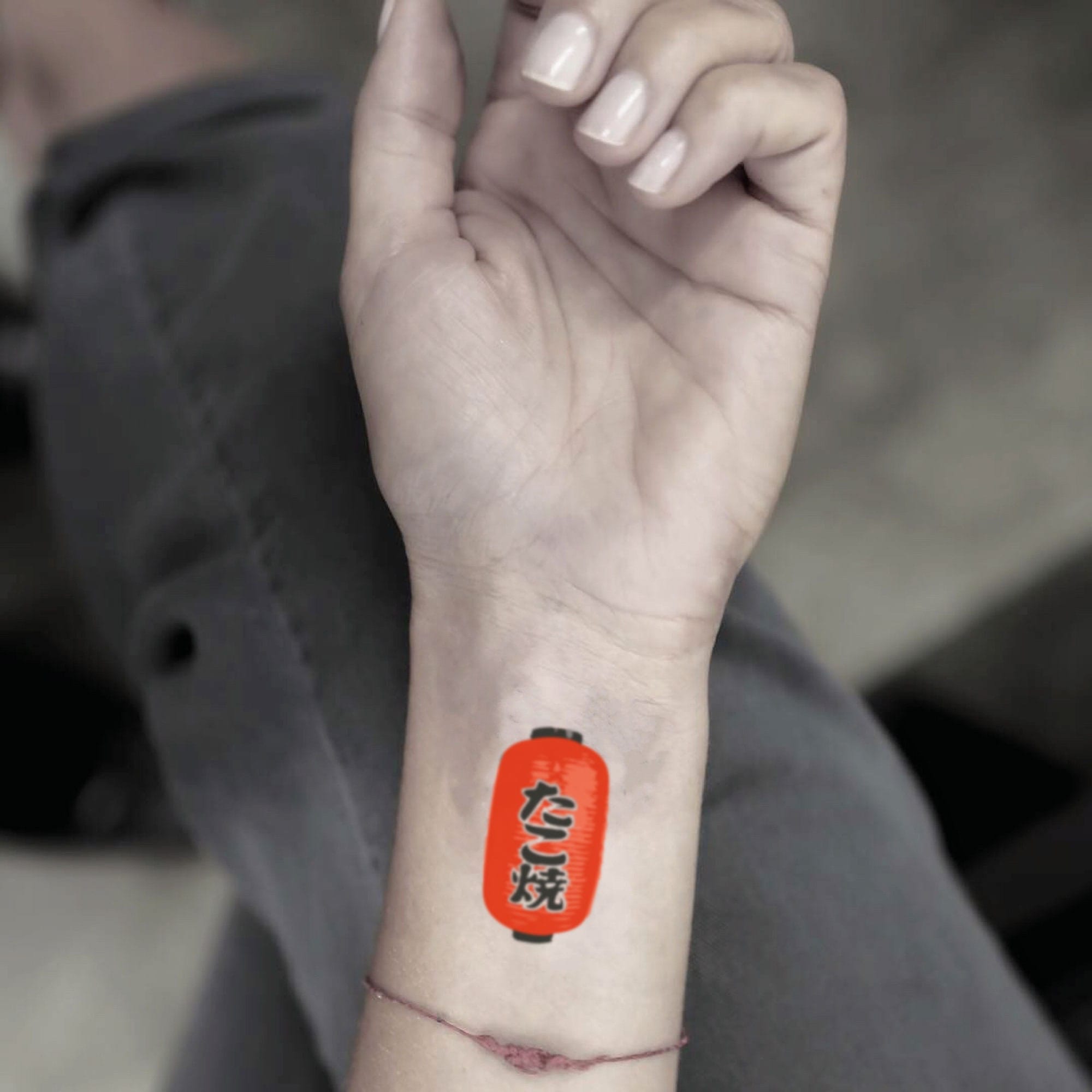 a small Japanese tattoo with a lantern