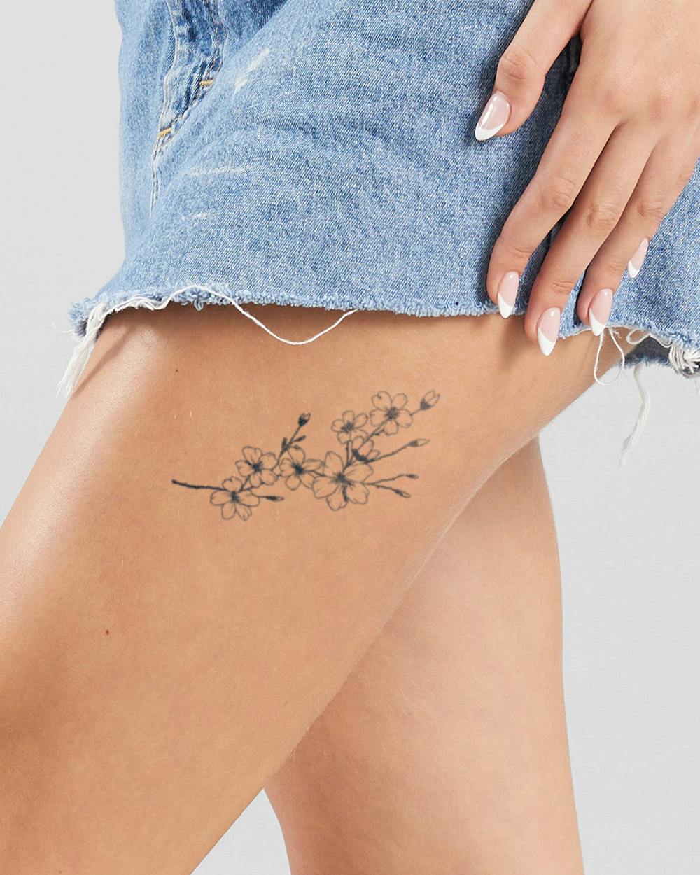 a small Japanese tattoo with flower design