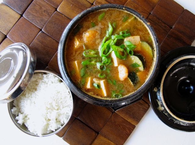 a steaming bowl of soup with rotten soybean paste