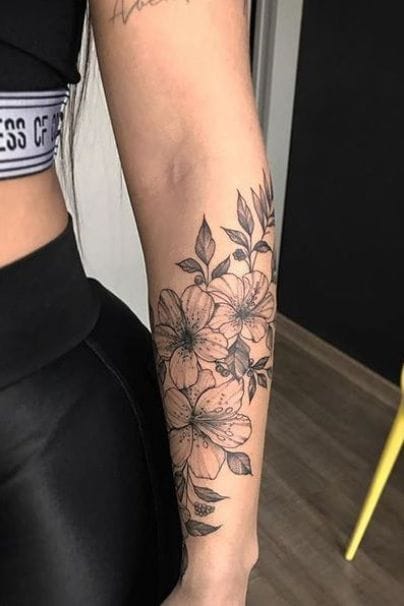 Delicate hibiscus blooms cascade down this forearm in stunning black and gray linework, creating an elegant botanical sleeve that feels both timeless and modern. The artist's skillful shading brings depth to each petal while maintaining clean, crisp lines that will age beautifully 🌺 Perfect placement that follows the natural curve of the arm for maximum visual flow.