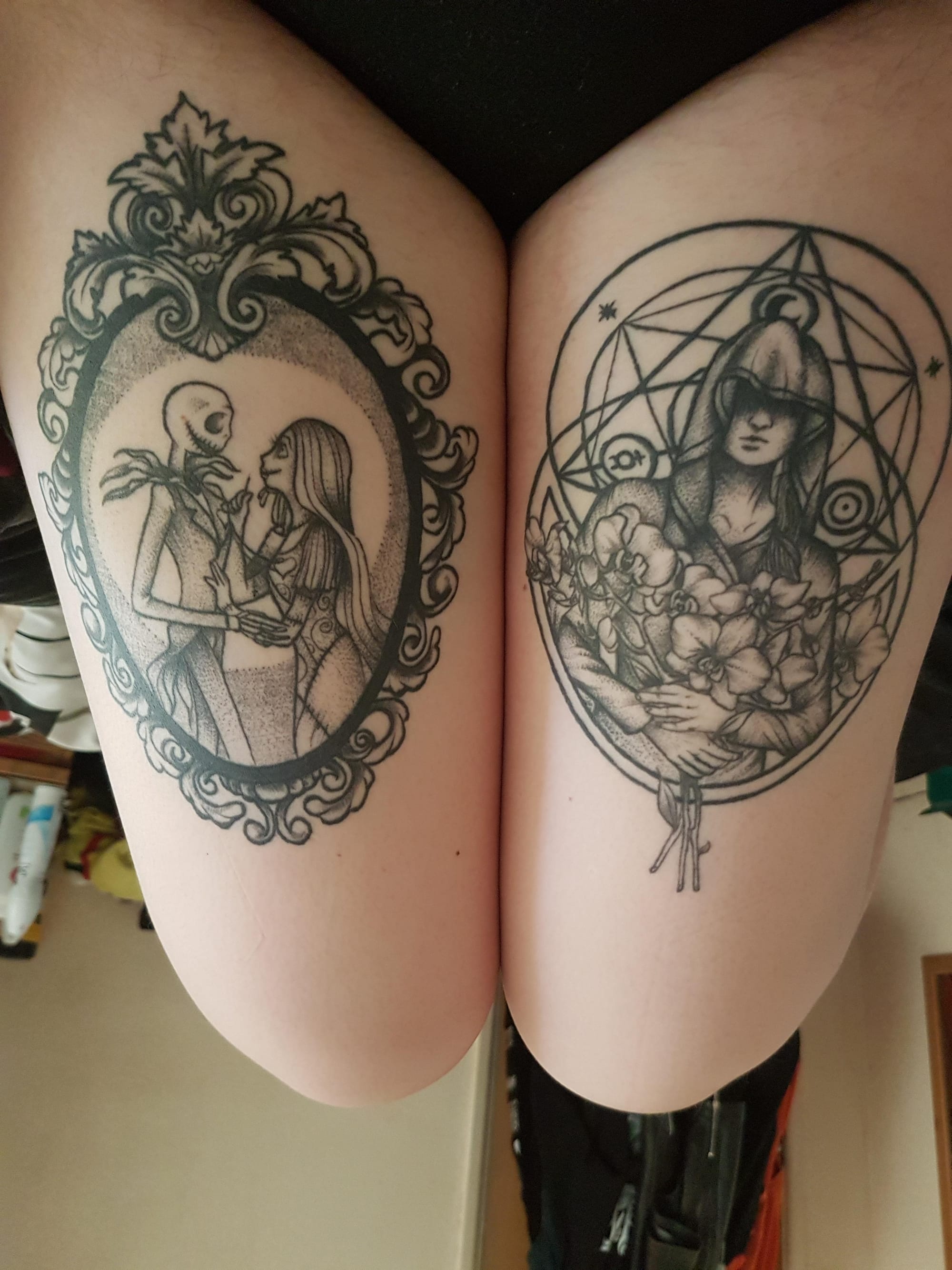 Gothic romance meets mystical artistry in this stunning thigh pair featuring Jack Skellington's tender embrace with Sally alongside a witchy botanical design. The ornate Victorian framing on the left contrasts beautifully with the geometric pentagram and flowing florals on the right, creating a perfect balance of dark whimsy and occult elegance. Bold blackwork and intricate lineart showcase the artist's masterful ability to blend Tim Burton's iconic characters with esoteric symbolism ✨