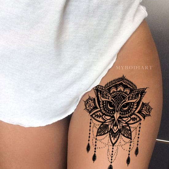 Graceful mandala petals bloom around a mesmerizing owl's gaze, creating an enchanting piece that flows beautifully along the thigh's natural curve. The intricate dotwork chains and delicate dangles add movement and mystique, transforming this design into wearable art that celebrates both wisdom and feminine power ✨