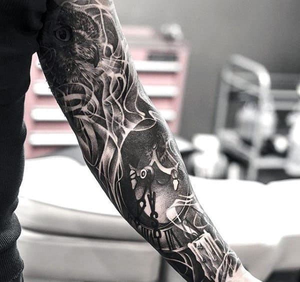Dark botanical elements intertwine with fierce animal imagery in this striking blackwork sleeve, creating a haunting garden where predators lurk among shadowy foliage. The artist's masterful use of negative space and intricate linework transforms the entire forearm into a living ecosystem of ink. Every detail flows seamlessly from one element to the next, proving that nature-inspired tattoos can be both beautiful and beautifully menacing 🖤