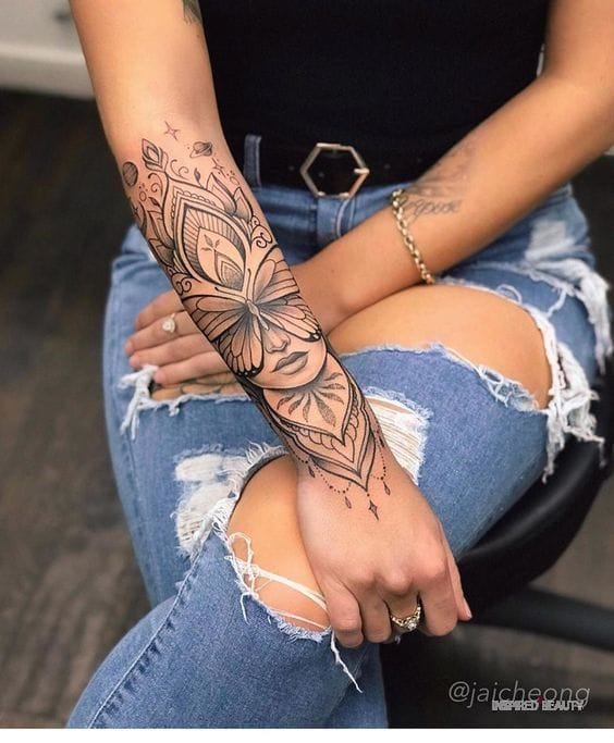 Delicate linework transforms this forearm into a botanical masterpiece, where intricate butterflies dance among ornamental flourishes and geometric patterns. The seamless flow from wrist to elbow creates stunning visual movement that perfectly complements the arm's natural curves. ✨ Pure artistry that proves black ink can be both bold and beautifully feminine.