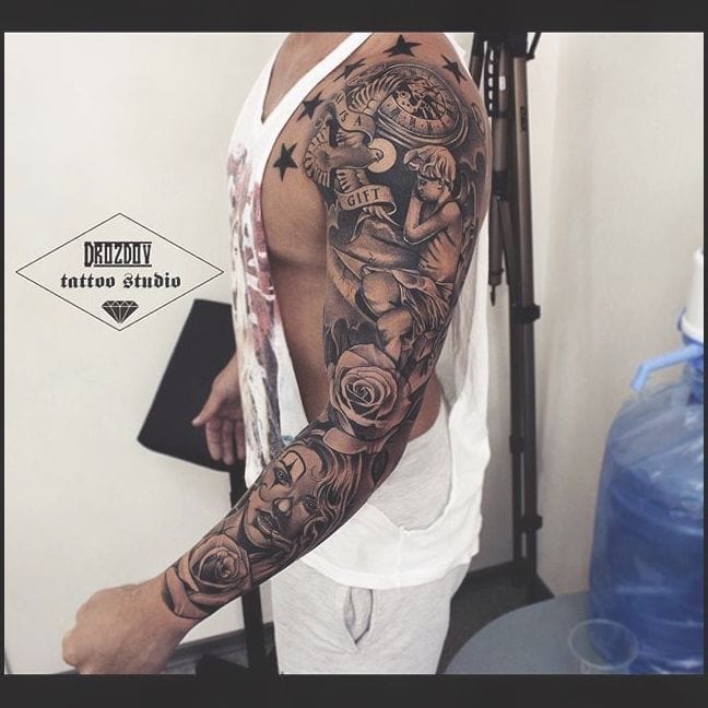 Intricate black and gray realism transforms this full sleeve into a mesmerizing narrative of feminine beauty and celestial wonder. The masterful shading technique creates incredible depth as roses, portraits, and starlit elements flow seamlessly from shoulder to wrist, showcasing the artist's exceptional skill in photorealistic tattooing. ⭐ This level of detail and composition proves why sleeve tattoos remain the ultimate canvas for storytelling through ink.