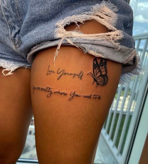 Delicate script flows across sun-kissed skin, paired with an intricate butterfly that seems ready to take flight at any moment. The meaningful message