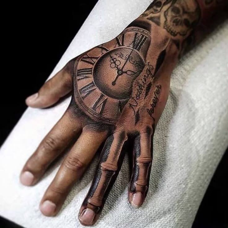 Time stands still in this masterfully crafted hand tattoo, where Roman numerals dance around a vintage pocket watch face in stunning black and gray realism. The skeletal finger bones extending down each digit create a hauntingly beautiful contrast, transforming the entire hand into a memento mori that speaks to life's fleeting nature ⏰ What makes this piece truly exceptional is how the artist seamlessly blended the clock's ornate details with anatomical precision, creating wearable art that's both Gothic and deeply meaningful.