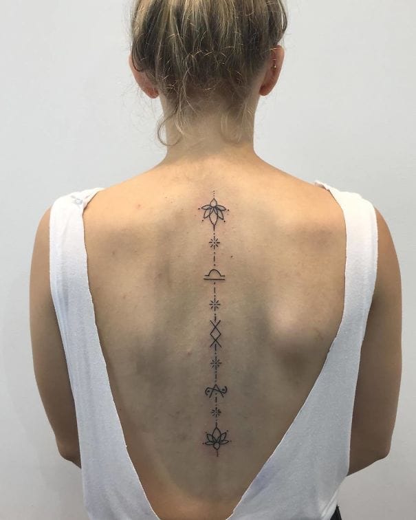 Delicate geometric symbols cascade down the spine like a mystical roadmap, each element perfectly balanced with fine line work that emphasizes precision over boldness. The vertical placement transforms the back into a canvas for spiritual storytelling, where lotus blooms, celestial stars, and sacred geometry create an elegant narrative from neck to lower back. This minimalist masterpiece proves that spine tattoos can be both deeply meaningful and visually striking without overwhelming the natural curves of the body ✨