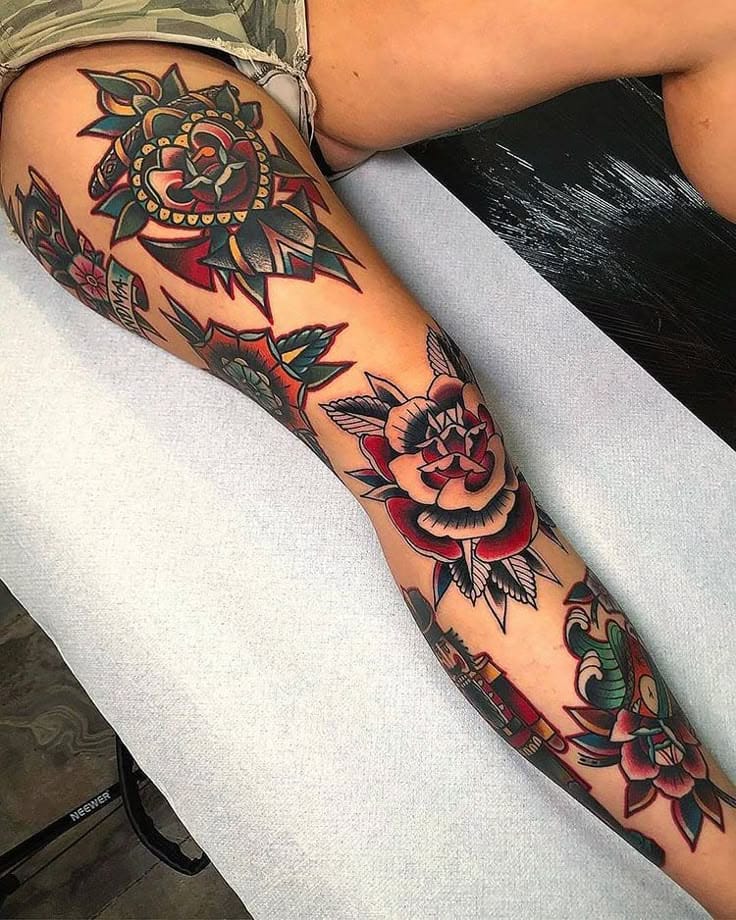 Bold traditional roses cascade down this leg in a stunning display of old-school tattoo artistry 🌹 The rich reds and deep greens pop against the skin, while ornate mandala-style detailing adds intricate geometric balance to the classic floral motifs. Perfect execution of American traditional style with that timeless, never-goes-out-of-fashion appeal.