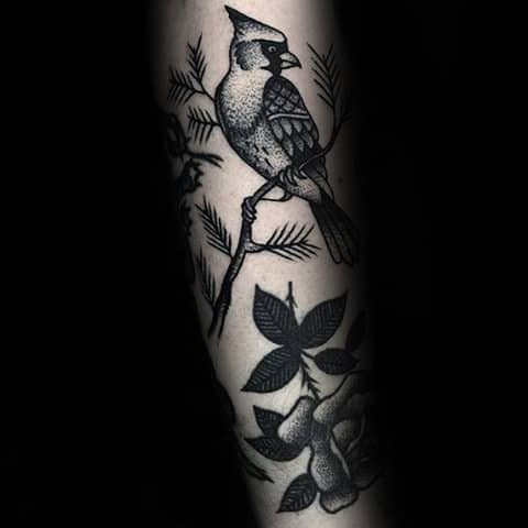Perched among delicate botanical elements, this stunning blue jay captures nature's intelligence and curiosity in bold black ink. The intricate feather detailing and surrounding foliage create a harmonious woodland scene that wraps beautifully around the arm's natural curve 🌿