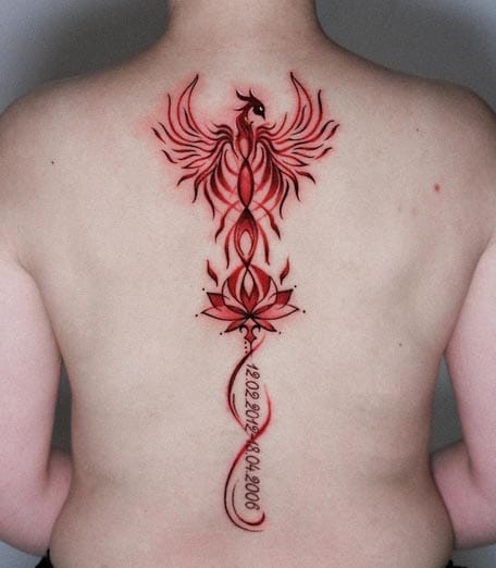 Cascading down the spine in vibrant crimson ink, this mythical phoenix rises from delicate lotus petals while elegant script flows beneath like liquid fire. The artist's masterful linework transforms the back into a canvas of rebirth and spiritual awakening 🔥 Perfect symmetry meets organic flowing curves in this stunning vertical composition.