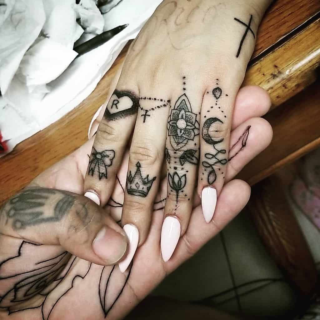 Delicate mystical symbols dance across each fingertip in this enchanting finger tattoo collection, featuring crescents, mandalas, geometric patterns, and celestial motifs. The intricate line work transforms ordinary hands into a canvas of spiritual storytelling, with each finger telling its own piece of a larger cosmic narrative ✨ Perfect for those who want their magic to be both subtle and constantly visible.