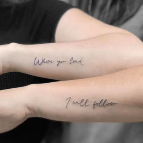 Delicate script flows across both forearms like a heartfelt promise made permanent, with