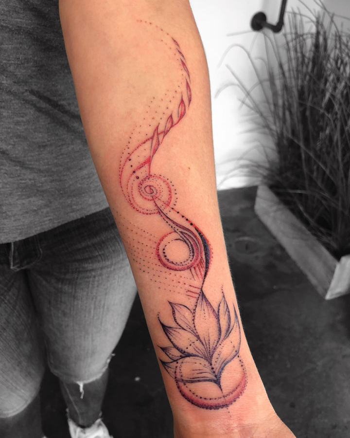 Delicate dotwork creates mesmerizing movement in this flowing forearm piece, where spiraling elements dance gracefully from wrist to elbow. The artist masterfully combines geometric precision with organic lotus petals, using fine linework and subtle shading to achieve an almost ethereal quality that seems to shimmer against the skin. ✨