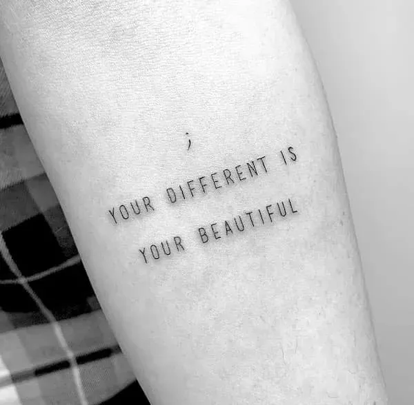 Delicate lettering transforms skin into a canvas of self-love with this minimalist affirmation tattoo. The simple black text